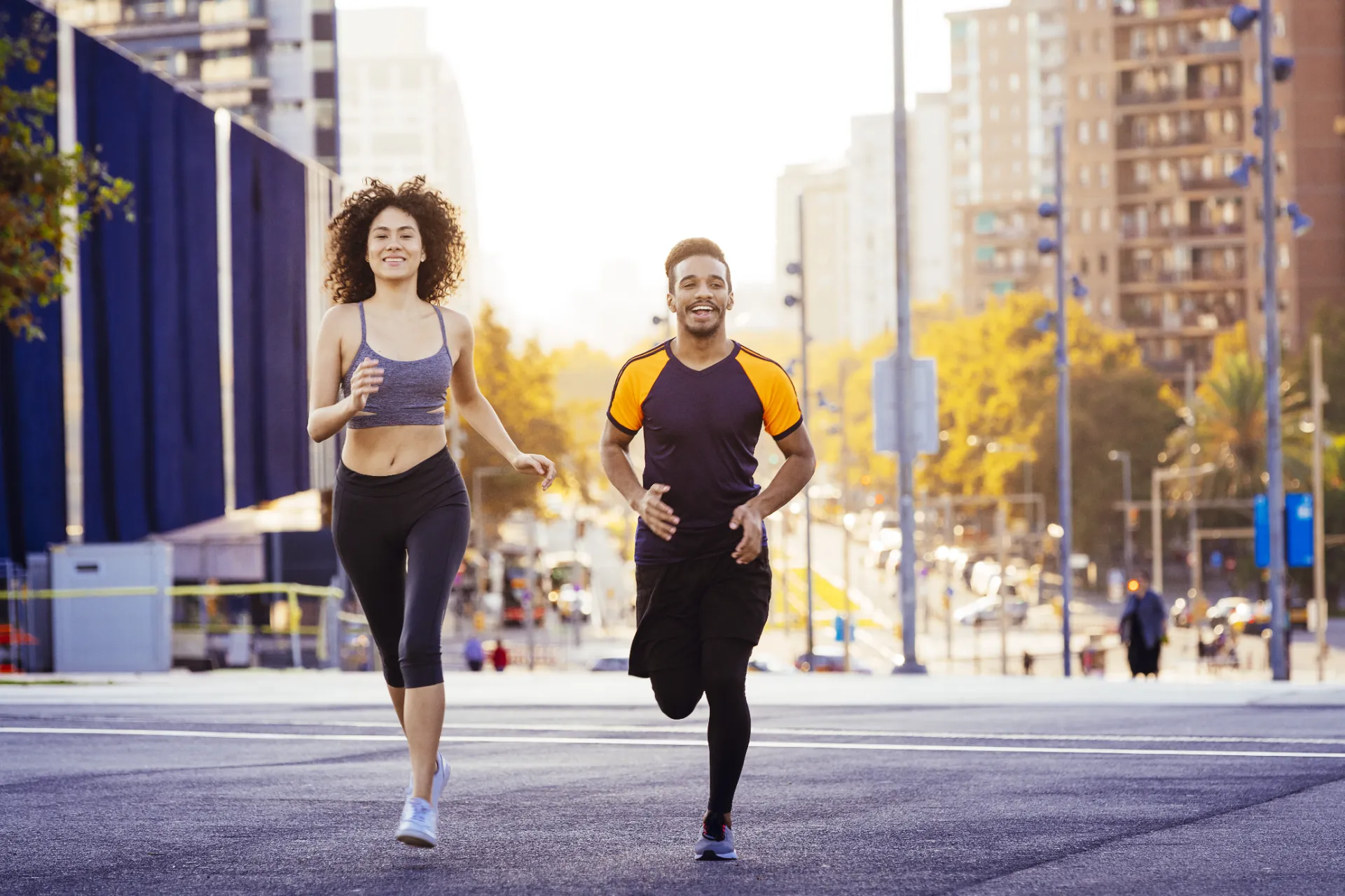latin woman and black man jogging in the city utc